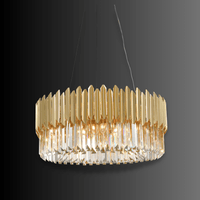 Zarrin Luceris architectural gold and crystal chandelier shown on dark background highlighting sculptural form.