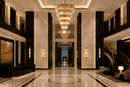 Zarrin Valerion grand crystal chandelier in a luxury double-height Manhattan Residence lobby with marble interiors