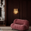 Luxury crystal wall light installed in refined living room with dark panel walls and soft ambient illumination