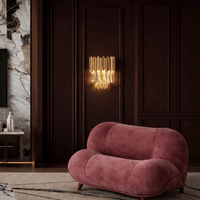 Luxury crystal wall light installed in refined living room with dark panel walls and soft ambient illumination