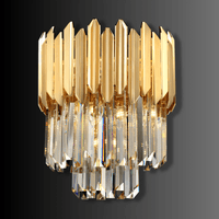 Luxury gold and crystal wall light with vertical faceted crystal drops and polished architectural metal frame