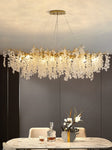 "Ethereal Vine Chandelier" installed in a different dinning room with bottle whisky on it. 