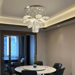 floral glass chandelier with premium stainless steel and glass design, installed above a round dining table 